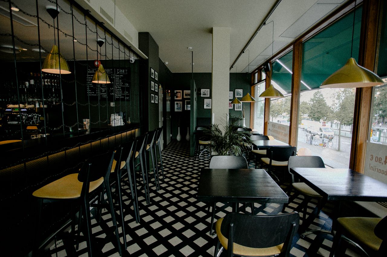 Modern cafe interior design with empty seating and unique lighting.