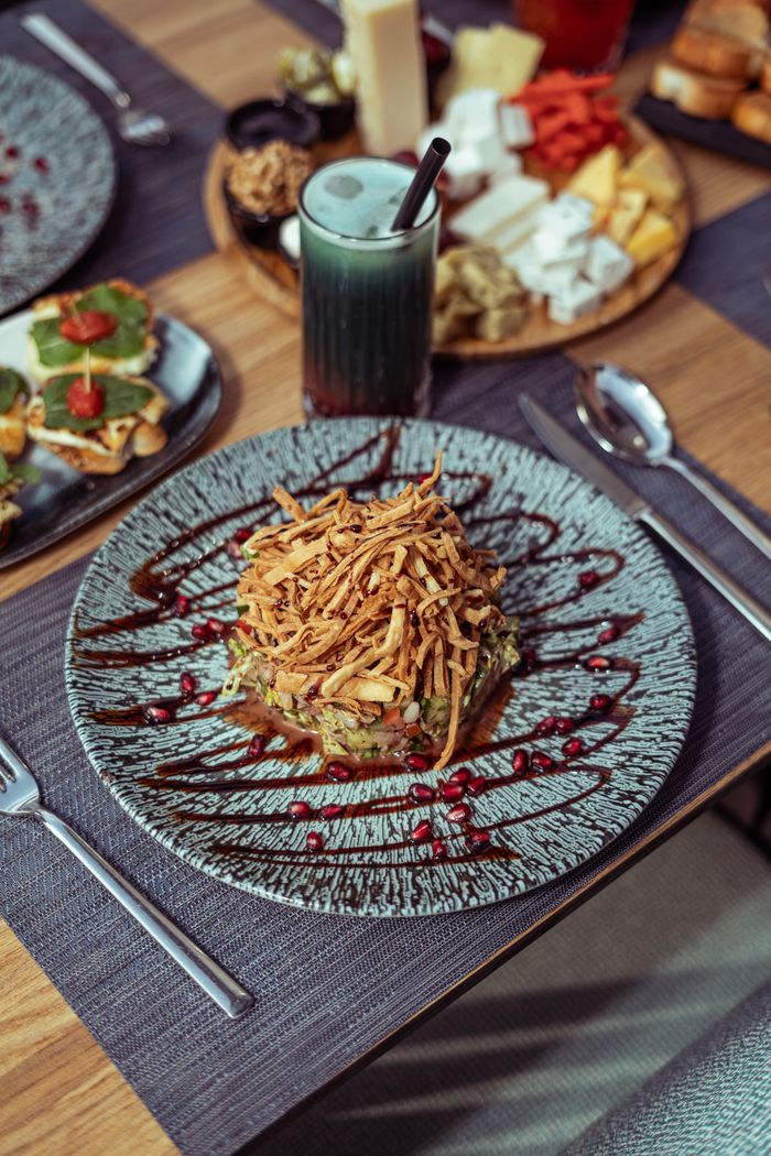 A delicious gourmet meal served with a variety of appetizers and a refreshing drink in Baghdad, Iraq.