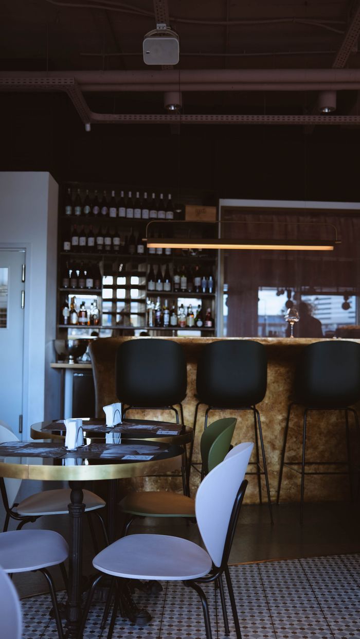 Modern bar interior in a Minsk café with sleek seating arrangement and ambient lighting.